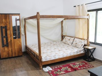 KIng size bedroom  with attached balcony and bathroom in Keralam farm stay Jabalpur, best farm stay