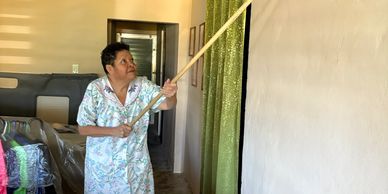 Our homeowner Miriam posed for this photo, expressing her gratitude for the restoration of her home 