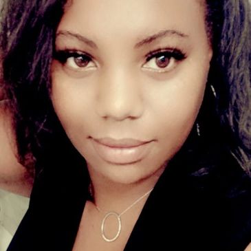 Close-up portrait of a woman with expressive eyes and a subtle smile.