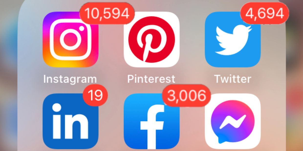 an iPhone with social media icons for Facebook, Instagram, Twitter and more with many notifications