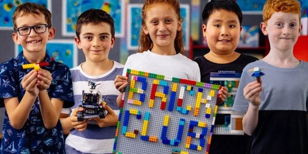 children showing the lego they have made 