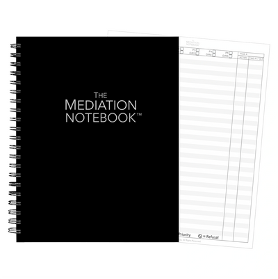 Black spiral-bound Mediation Notebook with a white page visible behind.