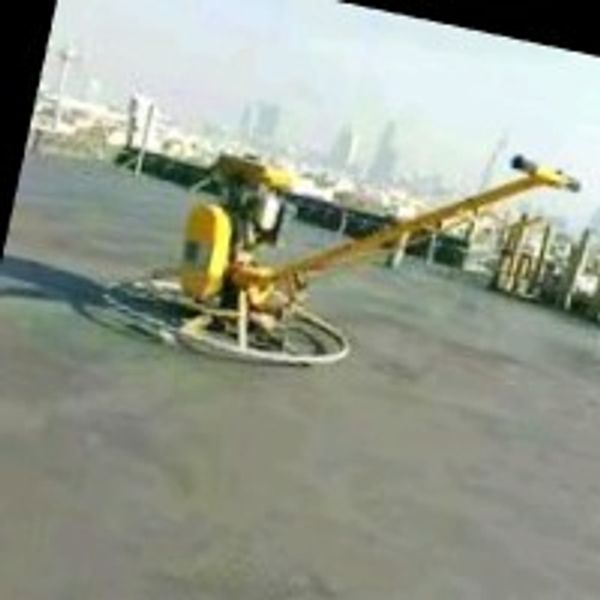 Concrete power trowel machine smoothing a large surface.