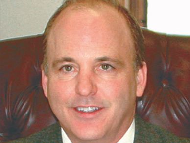 Portrait of a middle-aged man in a suit.