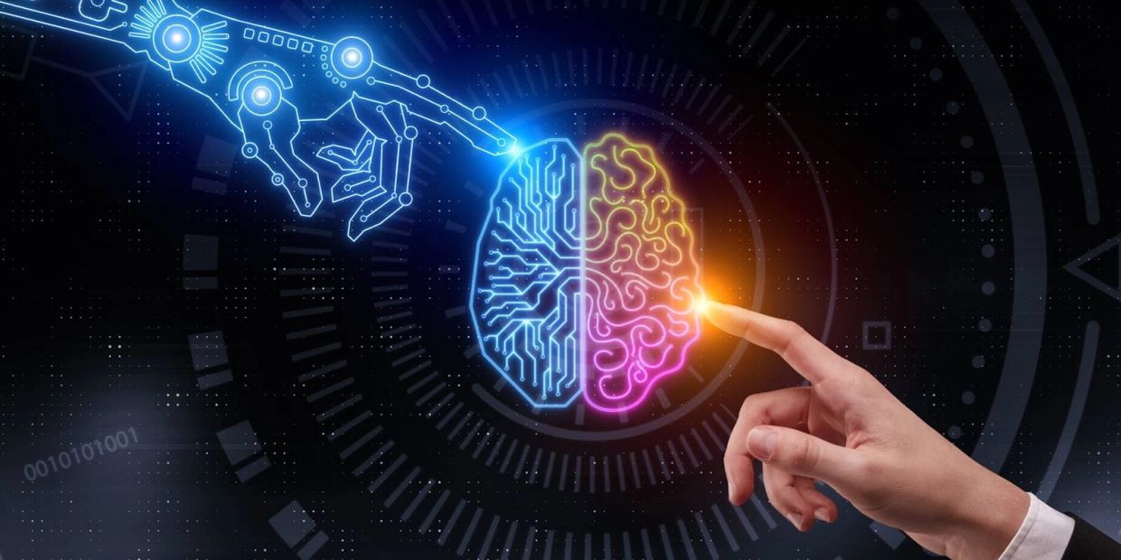 Human hand and robotic hand touching brain-shaped circuit.