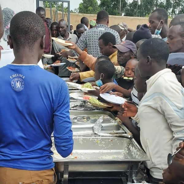 People gathering food from a buffet line.