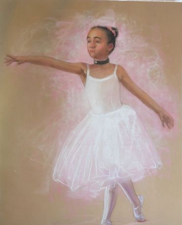Young ballerina in white tutu poised gracefully.