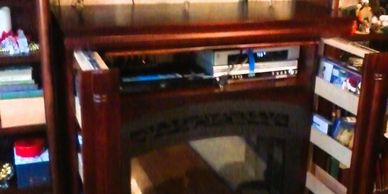 maximized electric fireplace surround with built-in hidden slide out DVD storage for ease of access.
