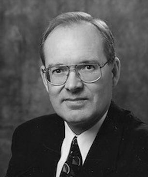 Black and white portrait of a man with glasses.
