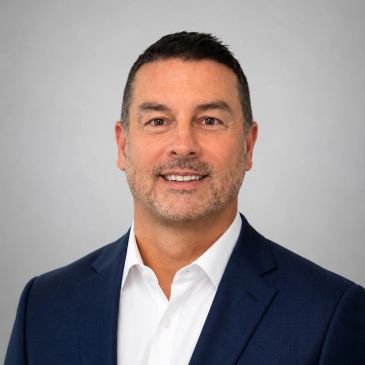 Professional headshot of a man in a suit.