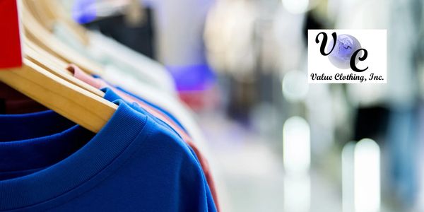Blue shirts hanging on wooden hangers in a store.