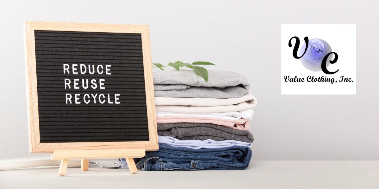 Sign with "Reduce, Reuse, Recycle" next to folded clothes