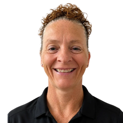 Smiling woman with curly hair wearing a black collared shirt.