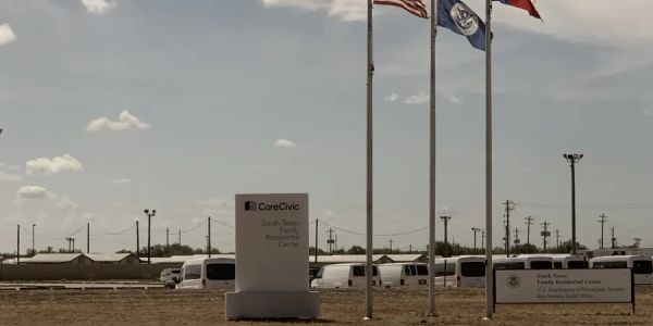 CoreCivic South Texas family residential center with flags.