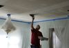 Charles stamping texture onto a ceiling