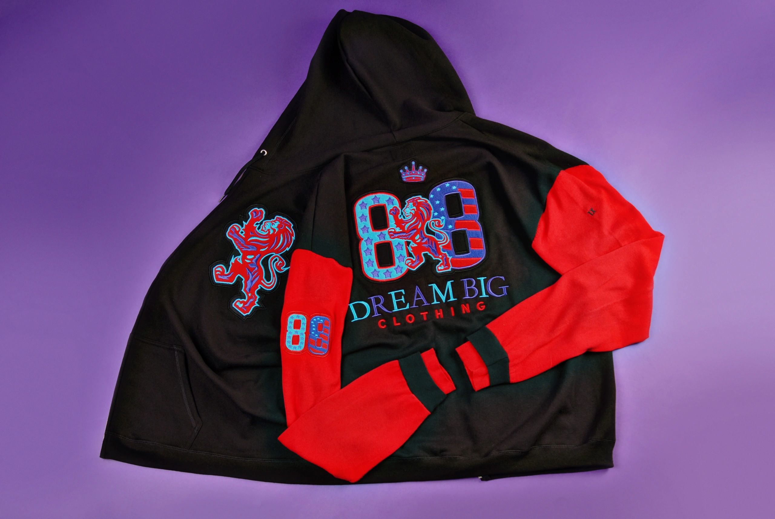 Black and red hoodie with lion and '88' designs on purple background.