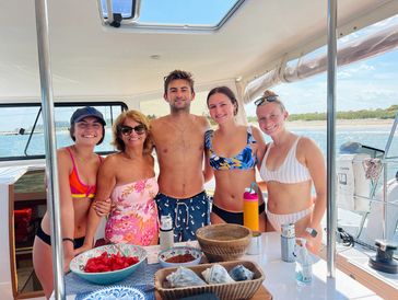 Family having fun on a sailing charter for a local summer activity