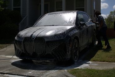 Black BMW iX exterior foam wash