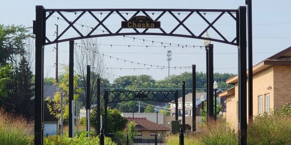City entrance sign for Chaska with decorative metal frames.
