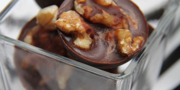Chocolate dessert made with coconut oil, cocoa, salt, green powered stevia, and walnuts