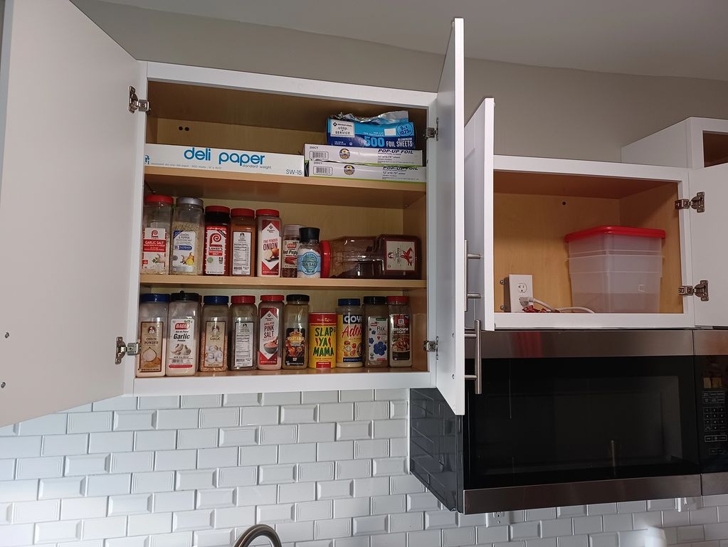 organized kitchen with functional cabinet storage.