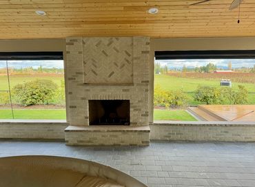 Covered patio with a brick fireplace in Ridgefield, WA