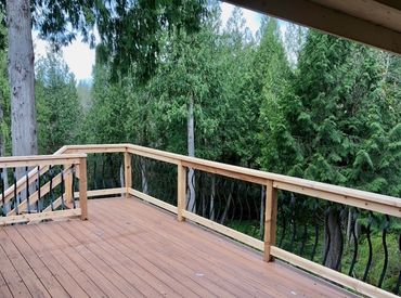 Spacious custom wooden deck with a sturdy railing in Battle Ground, WA