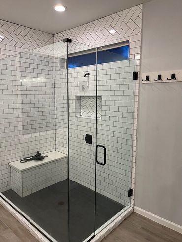 Modern glass shower with white subway tiles and black fixtures in Vancouver, WA