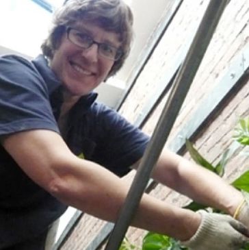 Amy working on a rooftop greenhouse