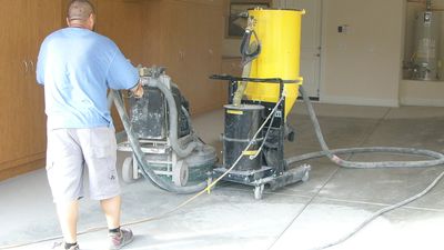 the preparation of the concrete by means of a walk behind grinder in conjuction of a dustless vacuum