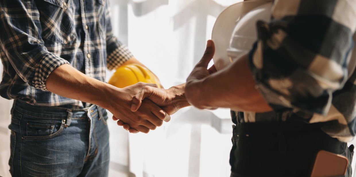 Electric utility training expert shaking hands with a student