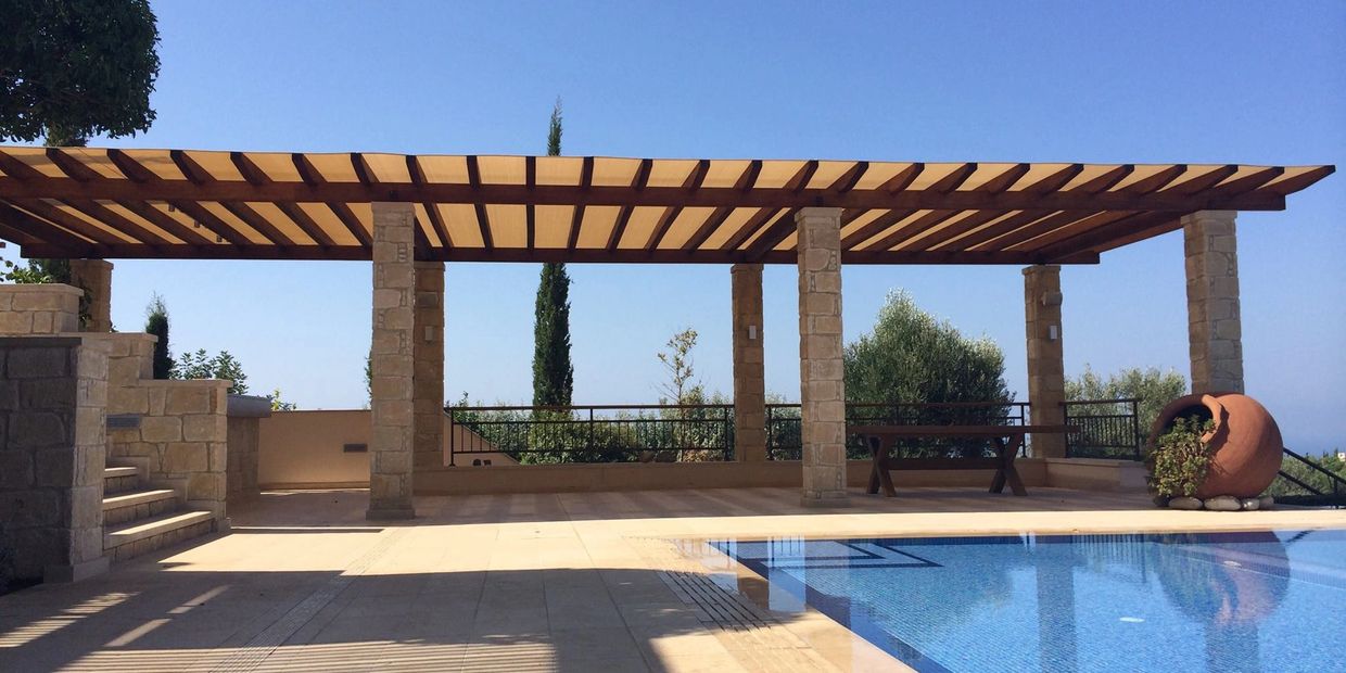 Custom-made pergola with shade canopy cover using shade cloth by Shadeports Plus, Cyprus.