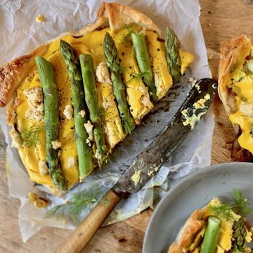 asparagus quiche with vintage knife on baking paper