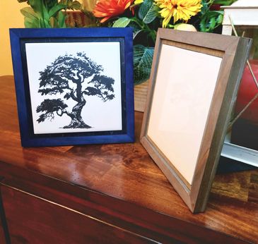 A picture showing two frames, in blue and grey, displaying 6-inch ceramic tiles.  