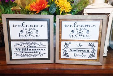 A lovely picture of a personalized family name etched into glass tile in a wooden frame. 