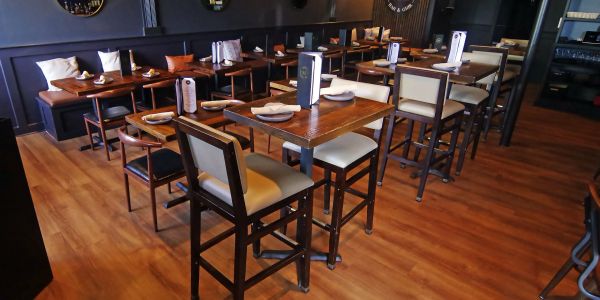Empty restaurant dining area with wooden furniture.