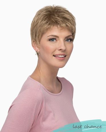 Smiling woman with short blonde hair wearing a pink top.
