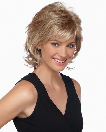Smiling woman with short blonde hair wearing a black sleeveless top.