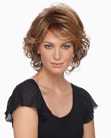Woman with short, curly light brown hair wearing a black top.