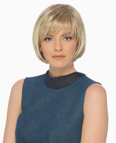 Woman with short blonde bob haircut wearing a sleeveless blue top.