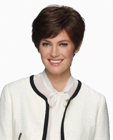 Smiling woman with short brown hair in a white blouse and jacket.