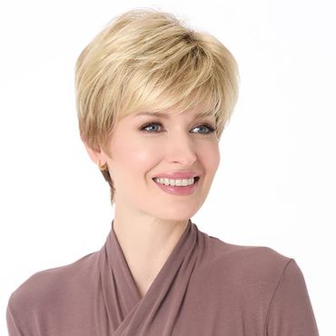 Smiling woman with short blonde hair wearing a mauve top.
