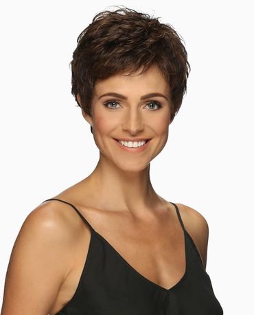 Smiling woman with short brown hair wearing a black spaghetti strap top.