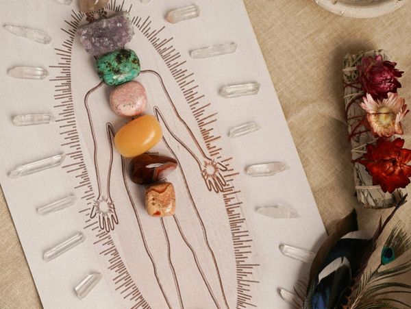 Crystals aligned on a human figure drawing for chakra healing.