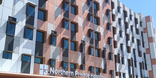 Modern facade of Northern Private Hospital with patterned windows.