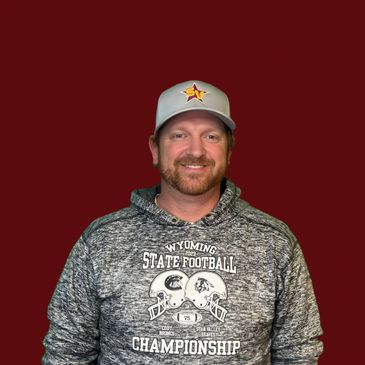 Man wearing a Wyoming State Football Championship hoodie and gray cap.