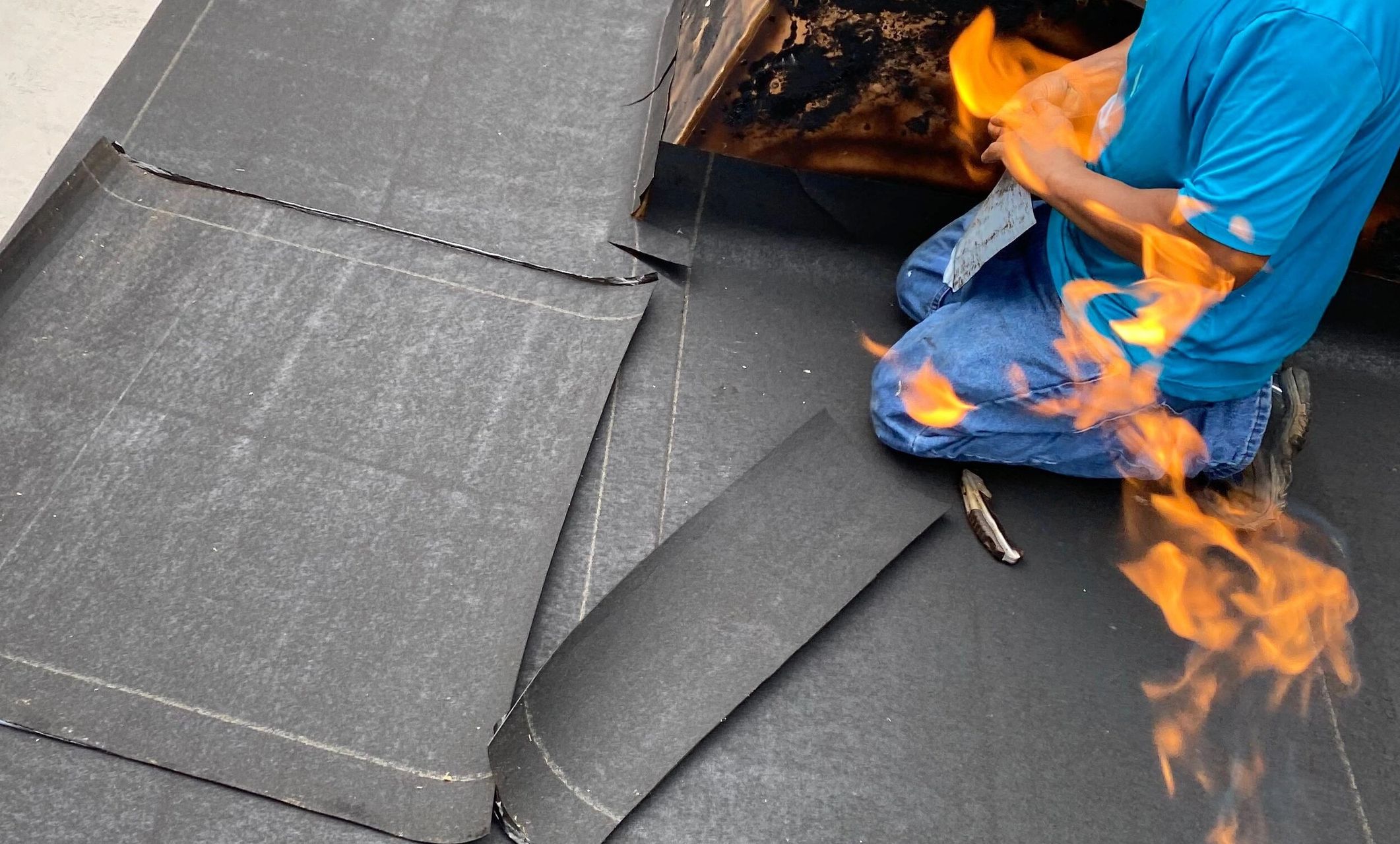 Torch down modified flat roof being put down on a roof in Washington DC
