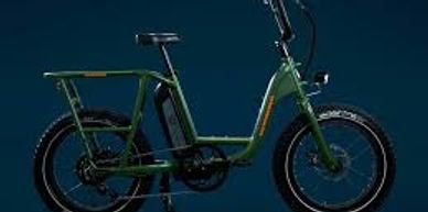Green electric bike with fat tires against a dark background.