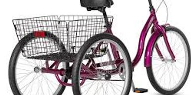 A purple adult tricycle with a large rear basket.