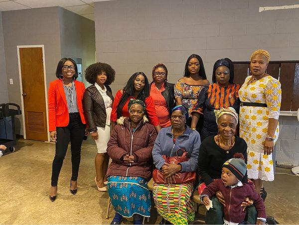 Group photo of women and a child indoors.